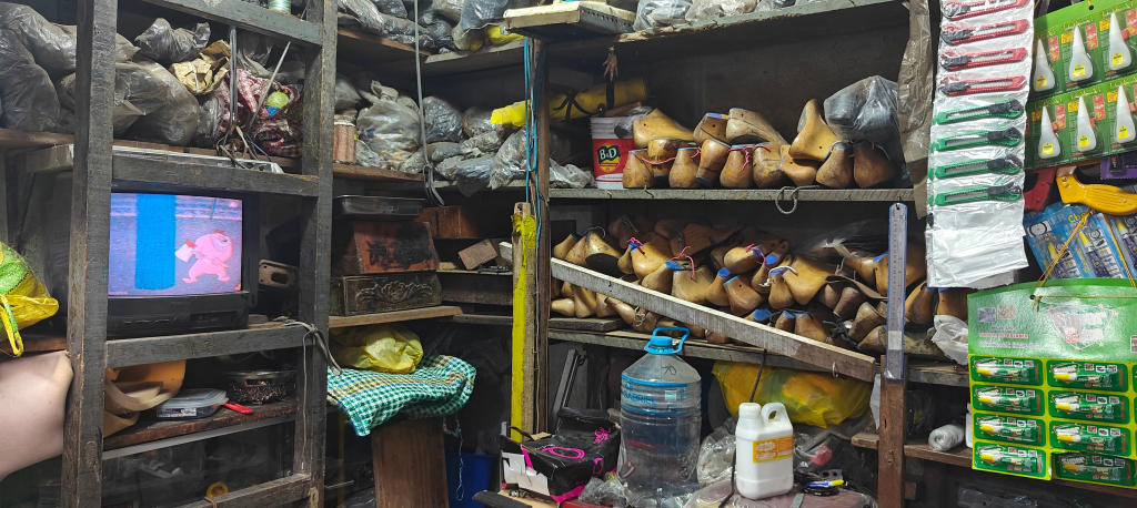 wooden footwear lasts stacked on shelf in a peruvain footwear market