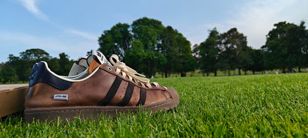 Song For The Mute x adidas Superstar Brown colourway photographed on the grass