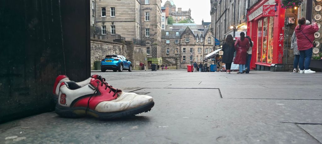 Discarded pair of Footjoy golf shoes on the streets of Edinburgh