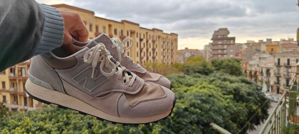 New balance 475 brighton grey in hand shot with city backdrop