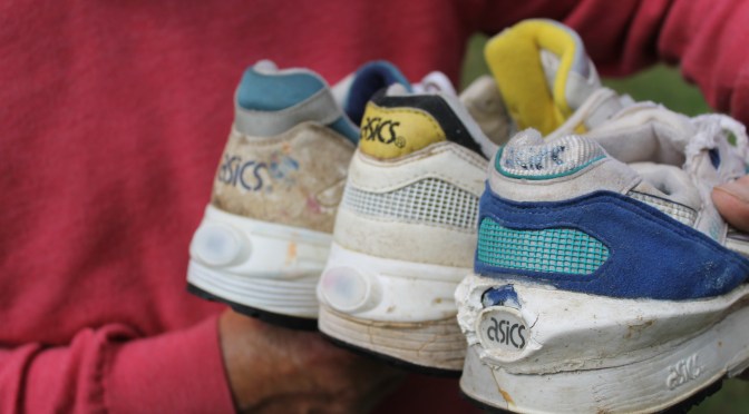 John Mott holding in his hand the ASICS Light Up Shoe prototypes including the white an yellow ASICS NITE-LYTE Production Pair sample