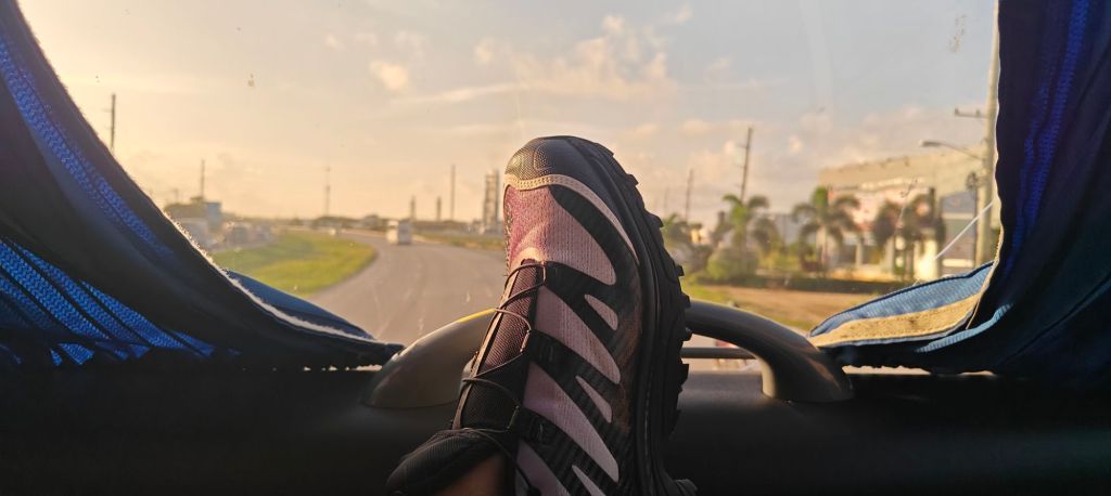 Salomon XT-4 from the top deck of bus heading to santo domingo with sunset in background and road ahead