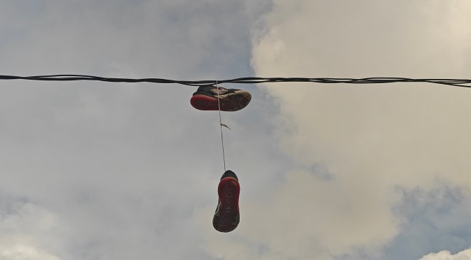 shoes hanging on telephone line in the Dominican Republic during sundown
