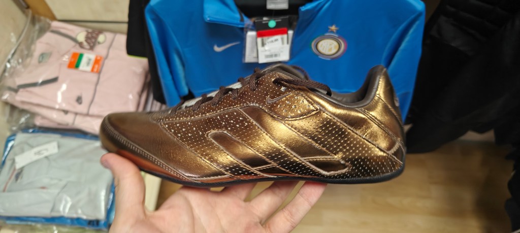 in-hand shot of retro nike 2000s product in old sicilian sports shop