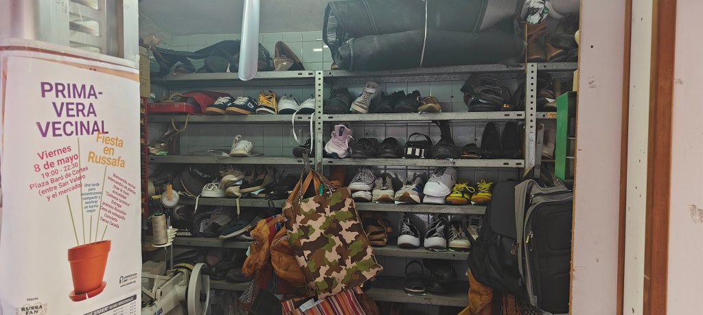 example of spanish cobbler shop with shoe shelves full of orders needing to be fixed