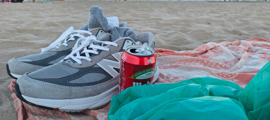 nb 990v6 as beach shoes enjoying a beer on the beach in valencia sand and towel backdrop