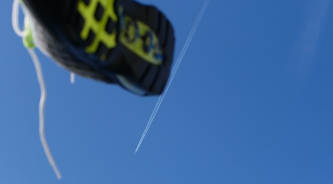 air max 95 in mid air flying through blue sky with jet lines in skyling backdrop